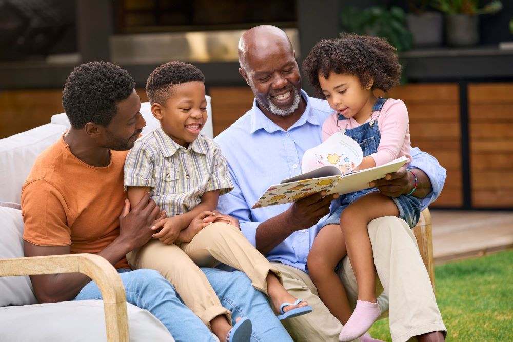 Grandparent reading a book to his grandkids