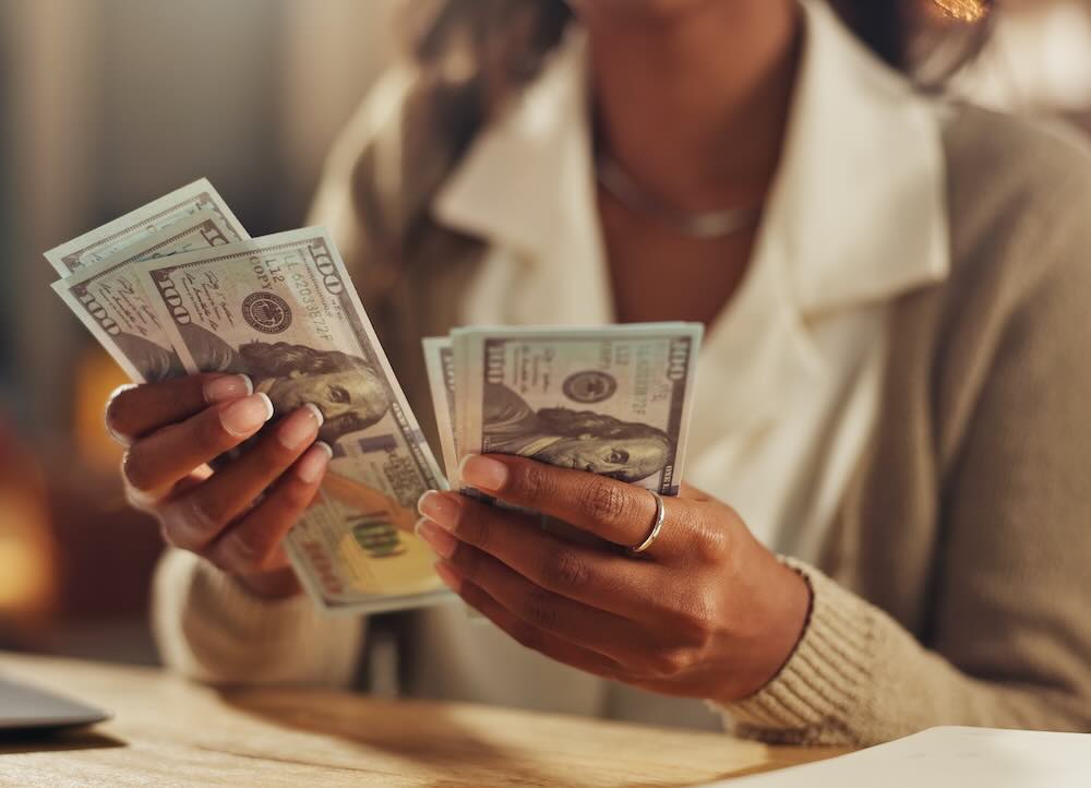Close up of a woman counting money 